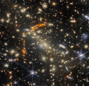 Webb Telescope Reveals Gravitational Lensing Effects in Distant Galaxy Cluster